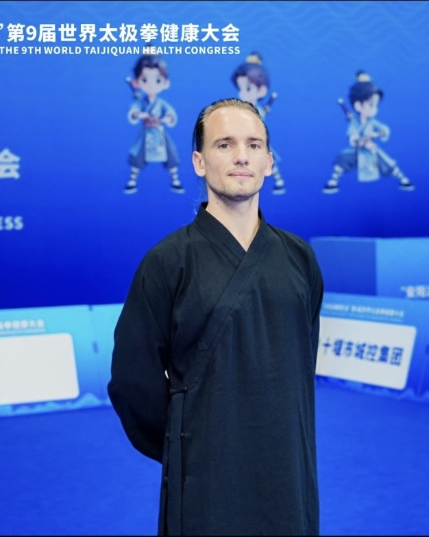 Maurijn in a black tunic at a taijiquan event